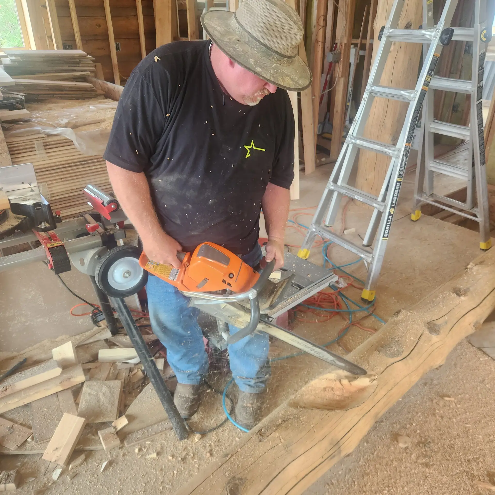 Caribou craftsman shaping a log during construction of a handcrafted log home