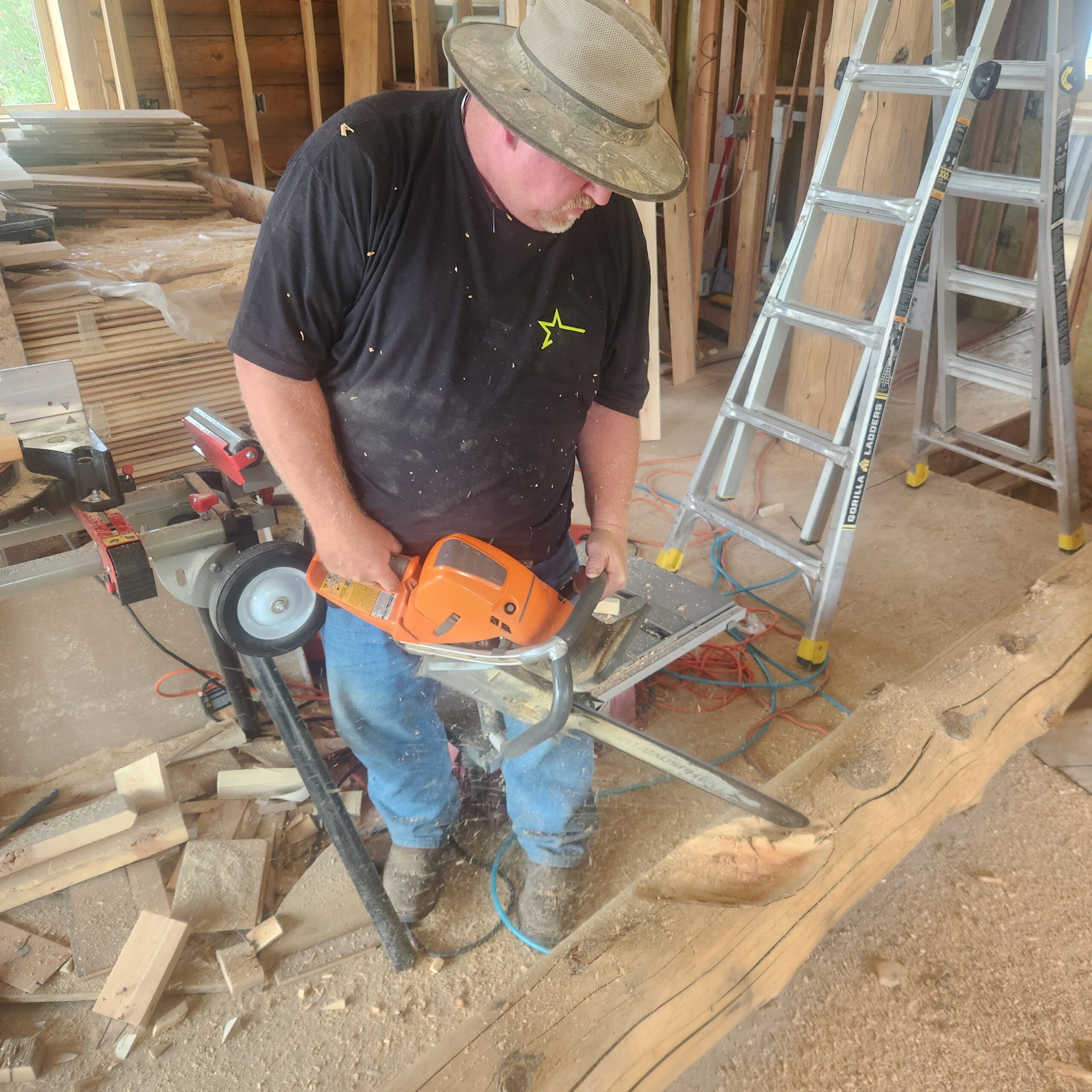 Caribou craftsman shaping a log during construction of a handcrafted log home