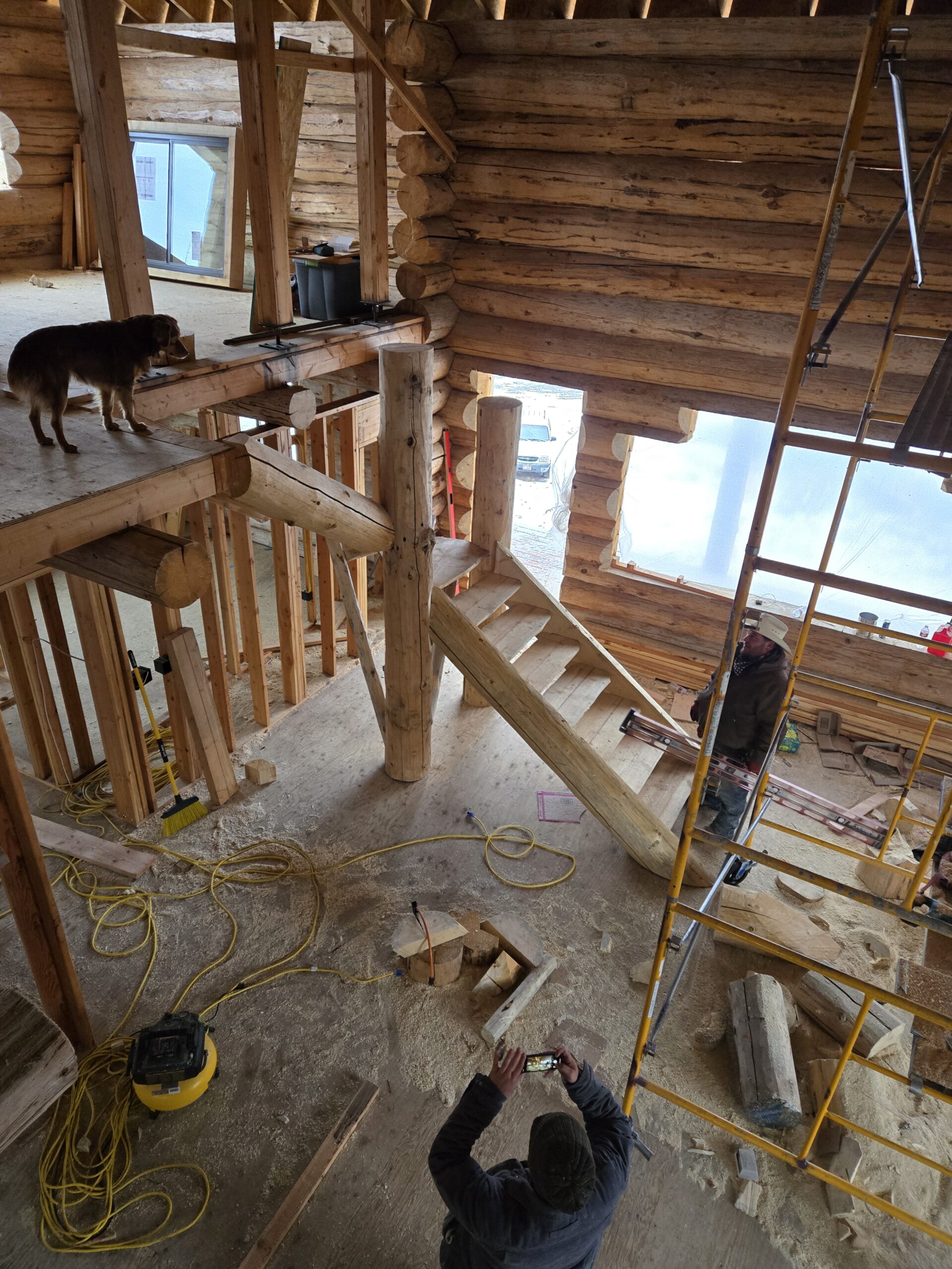 Caribou craftsmen working inside a handcrafted log home structure