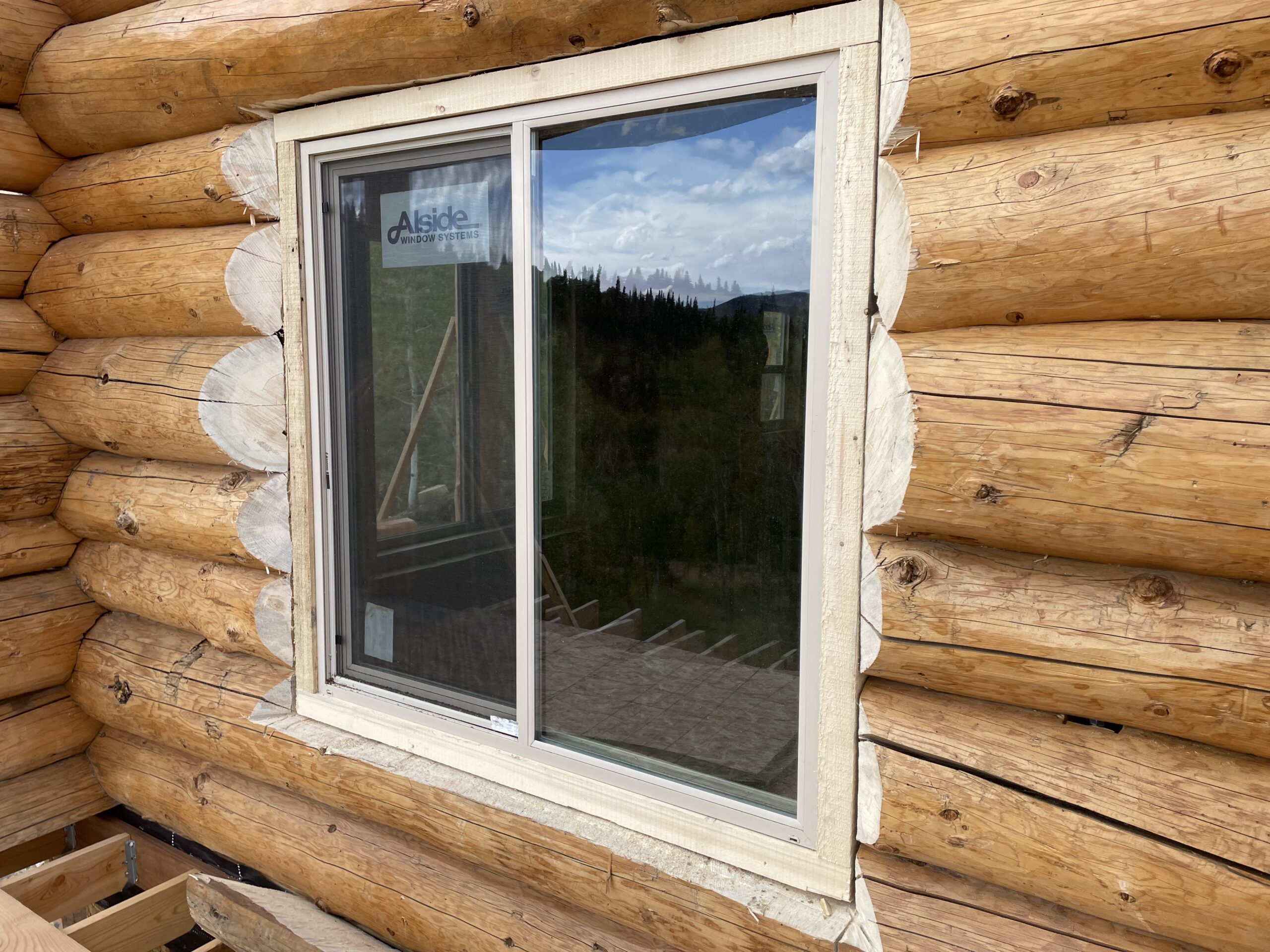 Close-up of handcrafted log details around a window opening