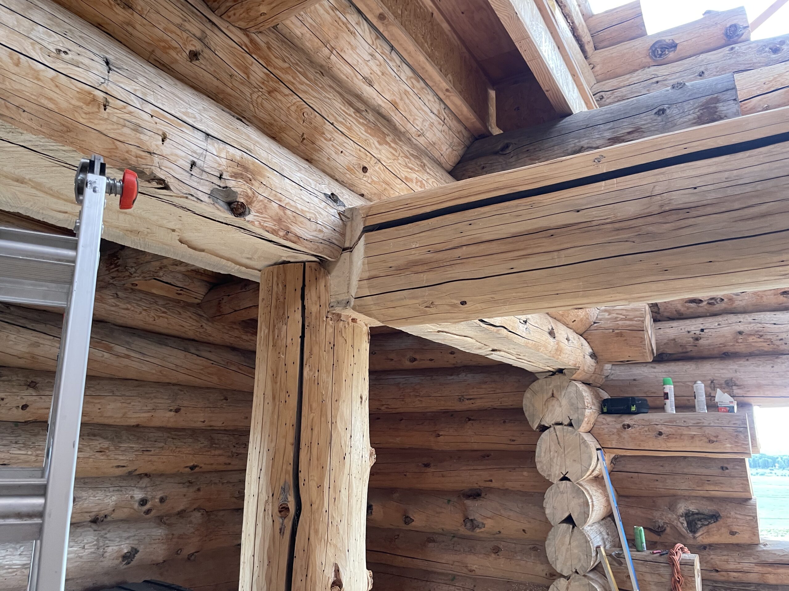 Handcrafted timber bearing on a natural log post in the Burton home