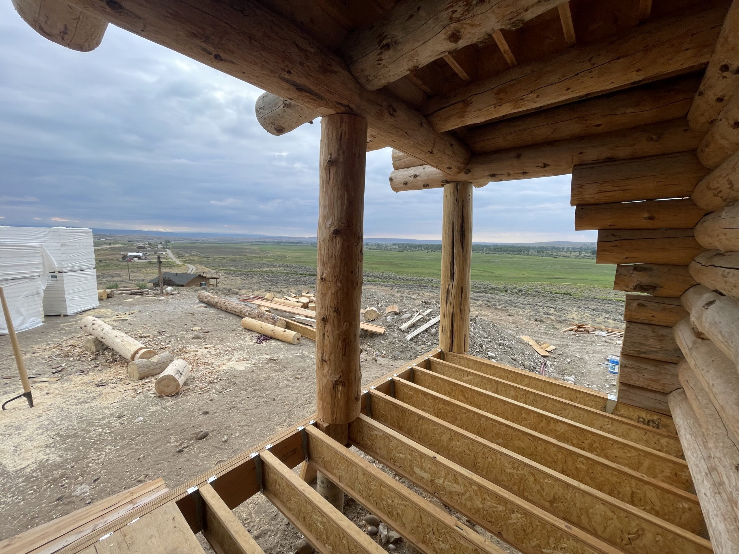 Covered exterior opening and log posts on the Burton project