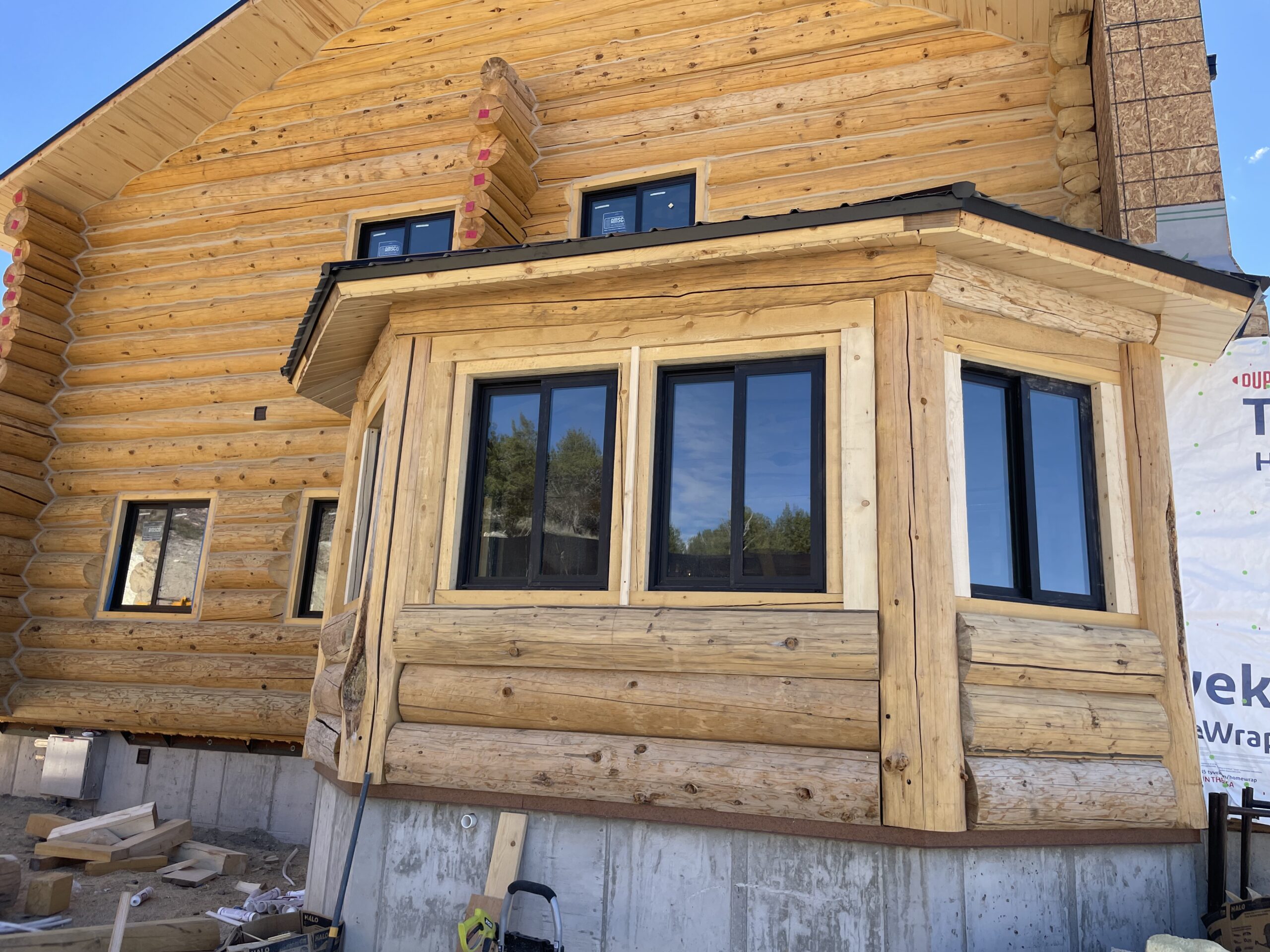 Handcrafted log wall construction on the Collard's project