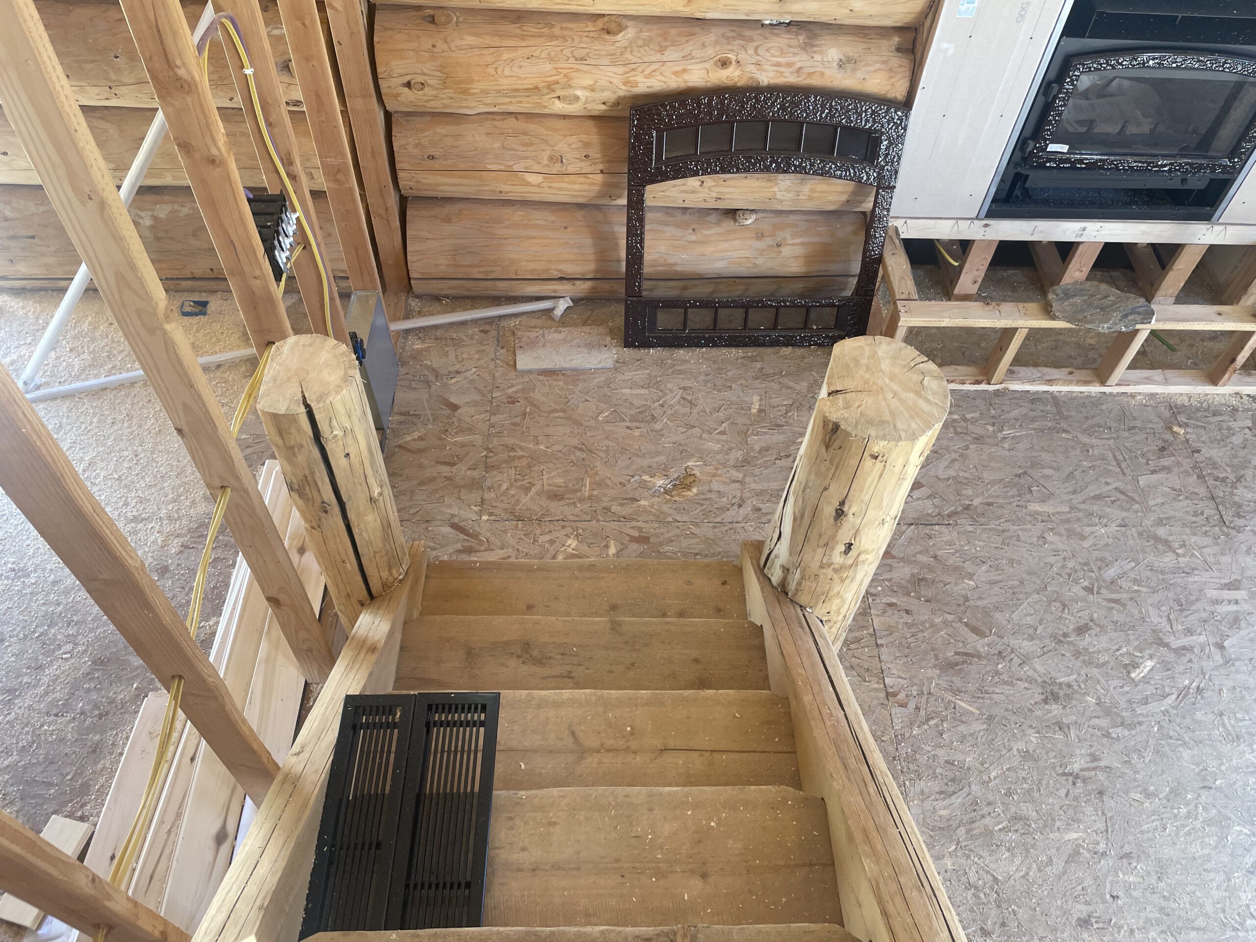 Interior log staircase and handcrafted railing on the Collard's home