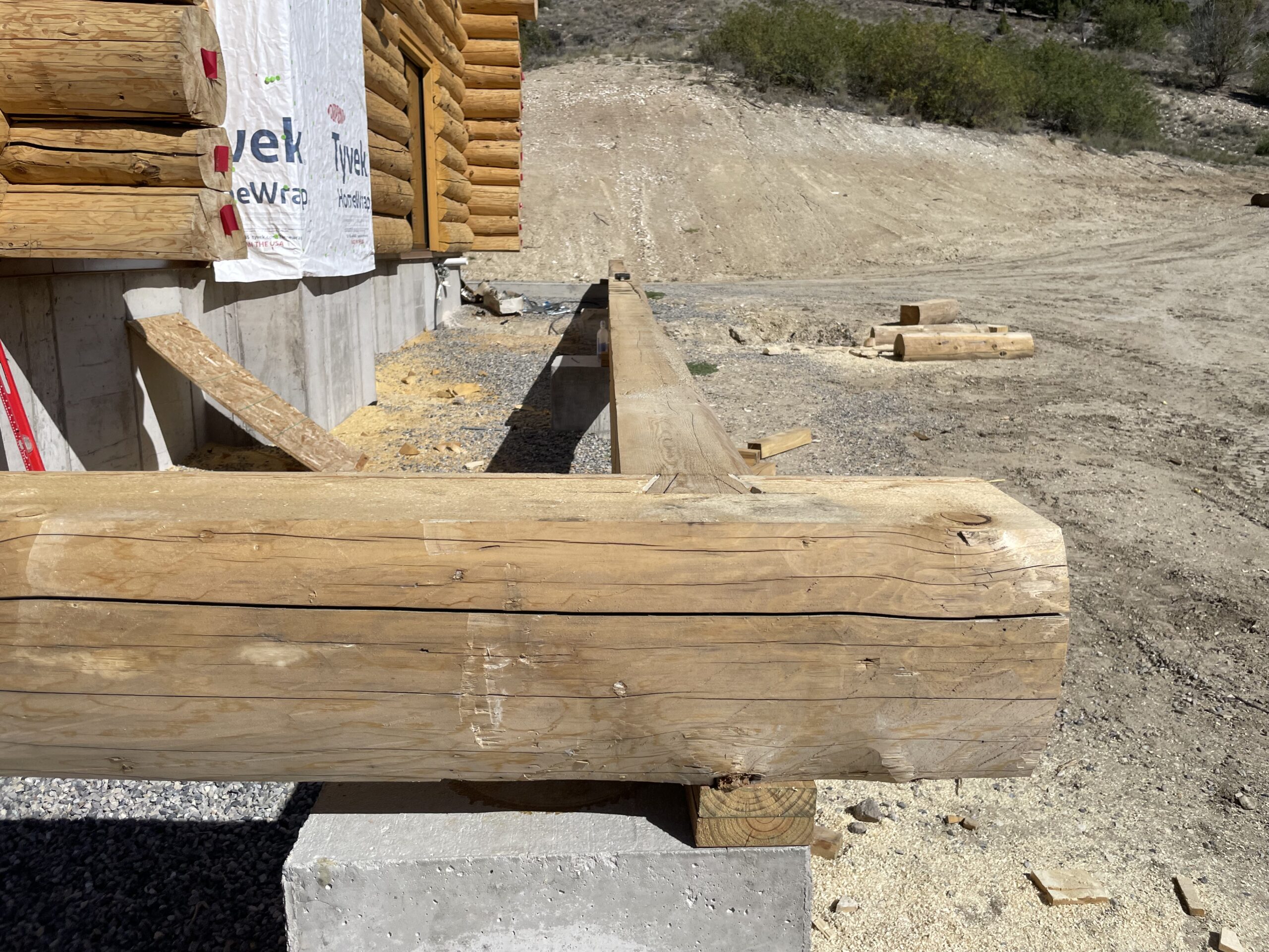 Craftsman fitting a structural log on the Collard's project